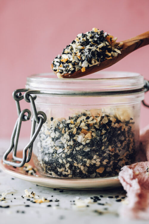 Holding a spoonful of Everything Bagel Seasoning over a jar