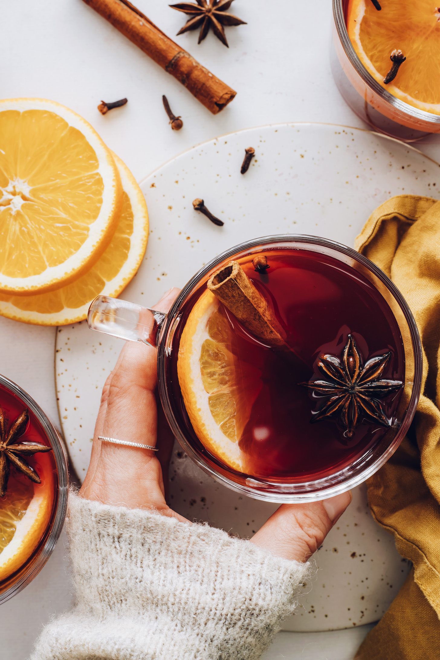 Hand holding a mug of tart cherry mulled "wine"