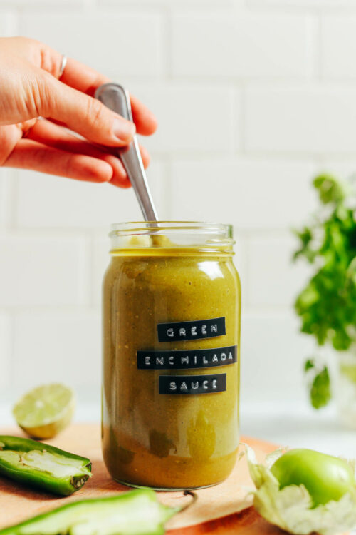 Stirring a jar of green enchilada sauce