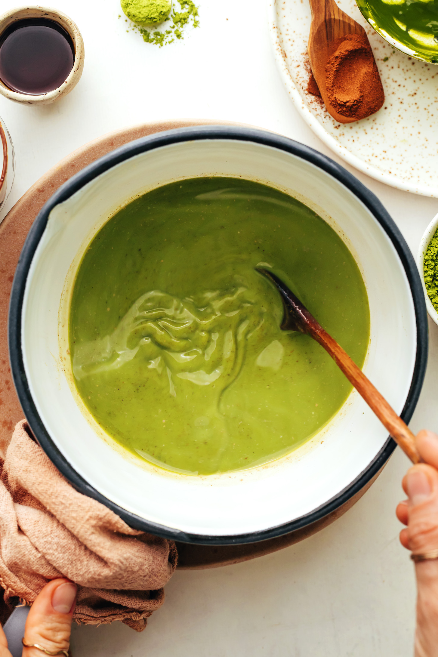 Stirring dissolved matcha powder into  warm dairy-free milk