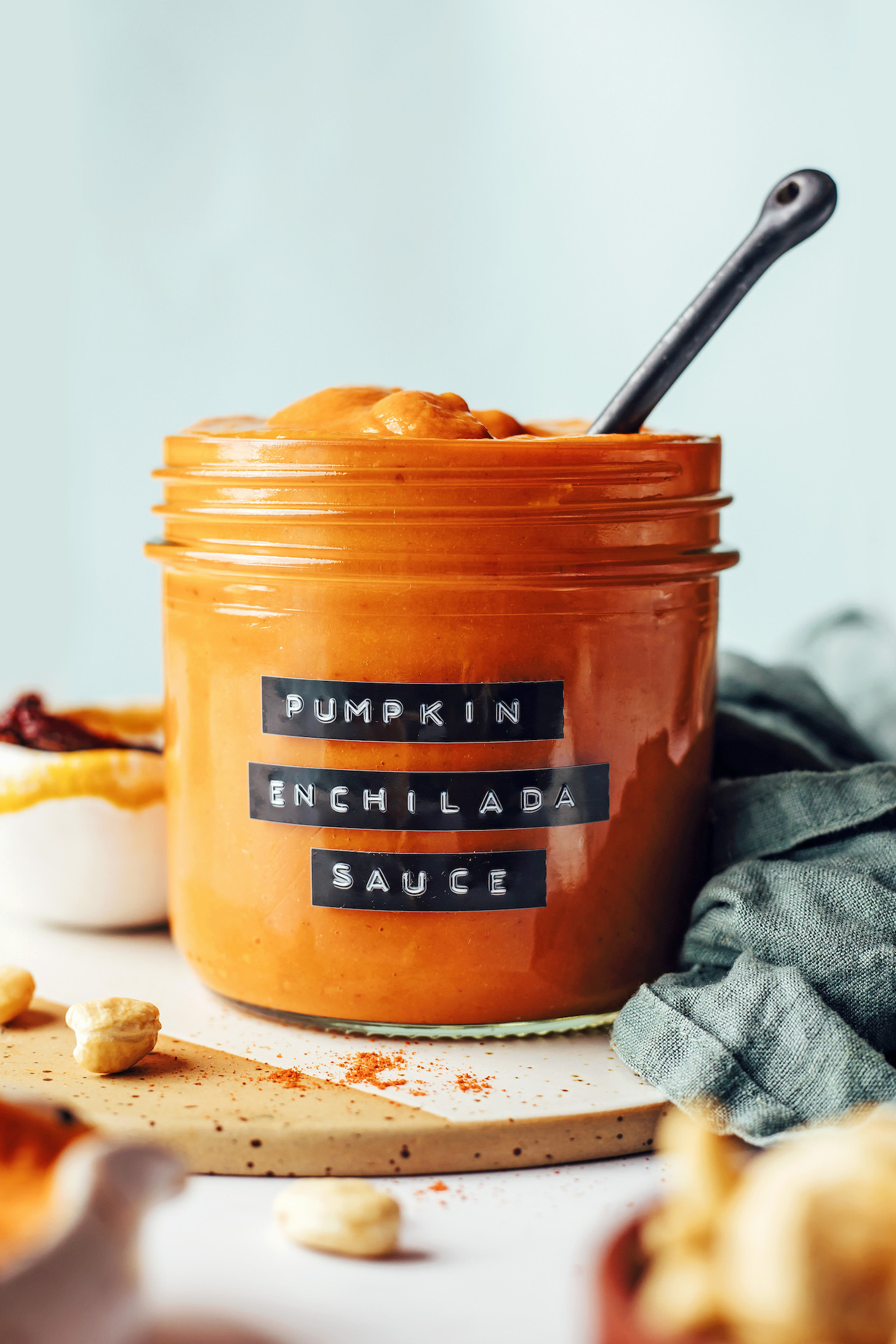 Side view of a glass jar of pumpkin enchilada sauce