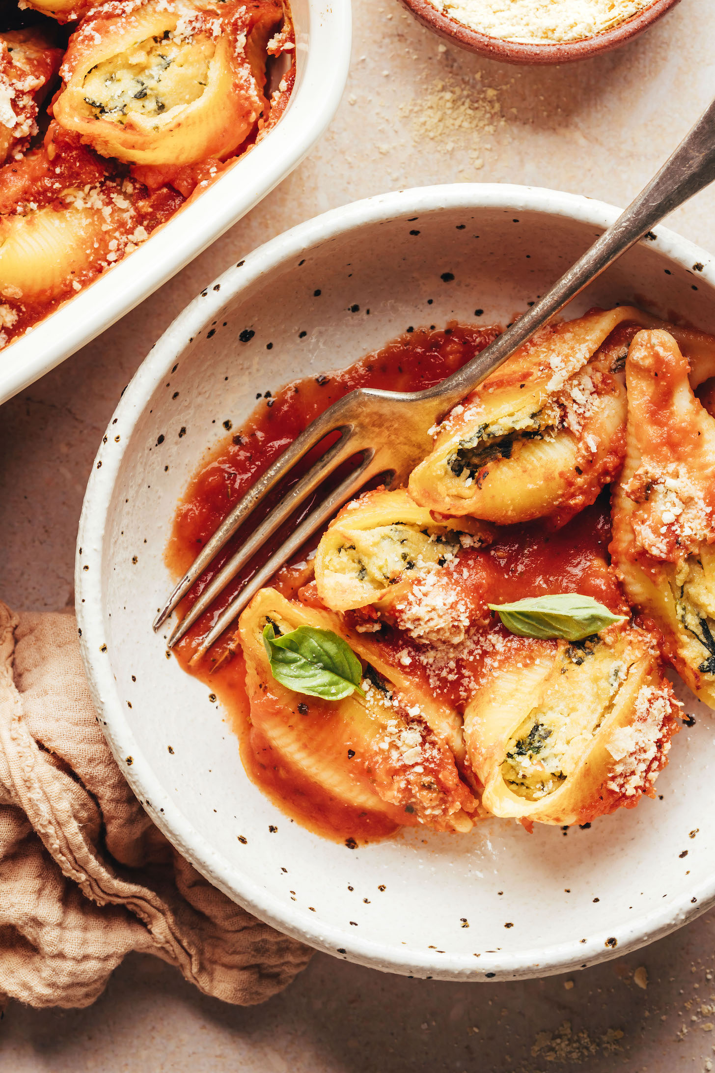 Baking dish and bowl of vegan stuffed shells