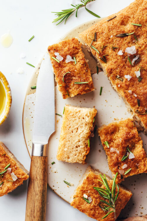 Slices of gluten-free focaccia bread next to the remainder of the loaf