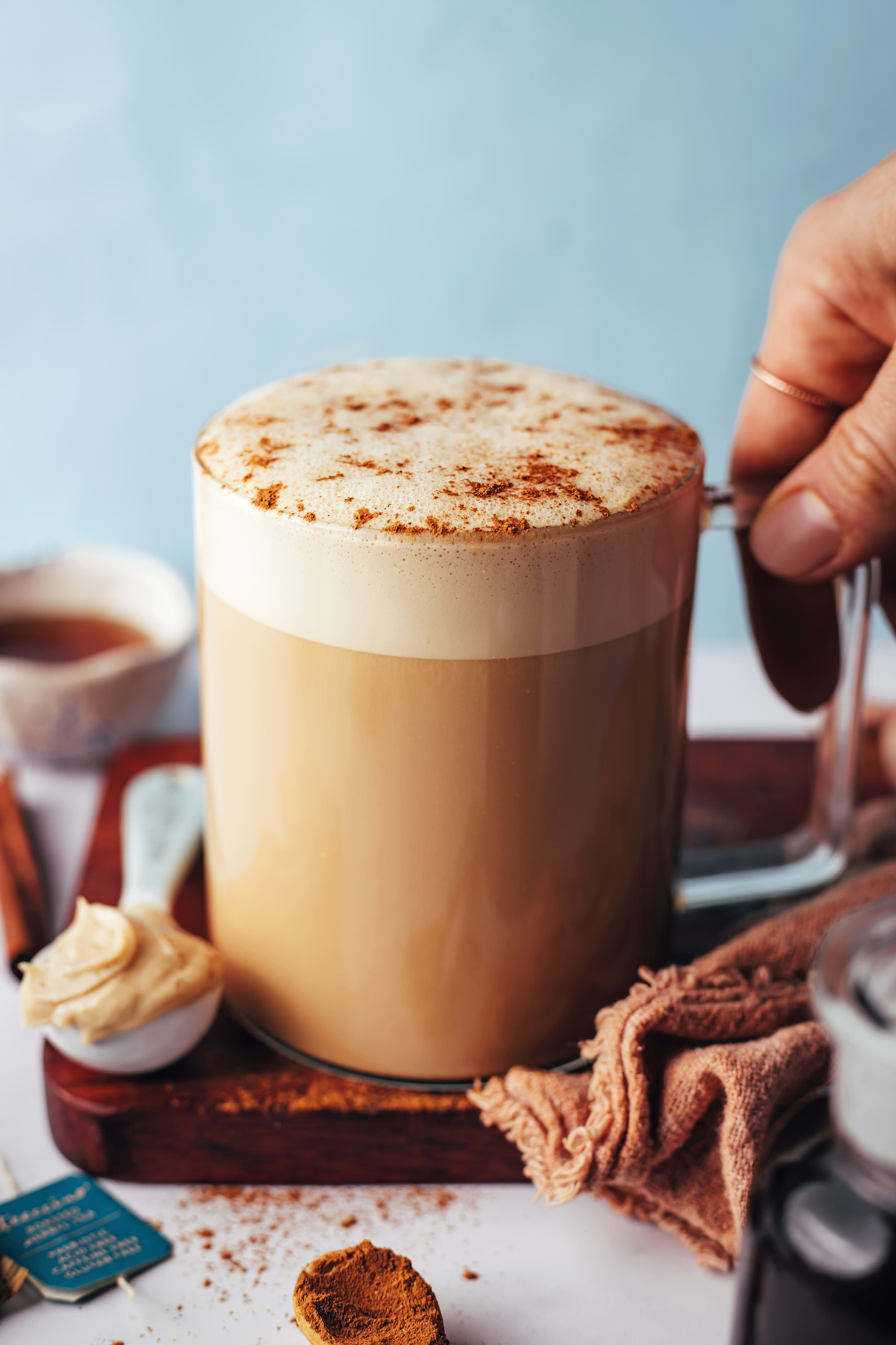 Hand holding a mug of our dandelion tea latte recipe