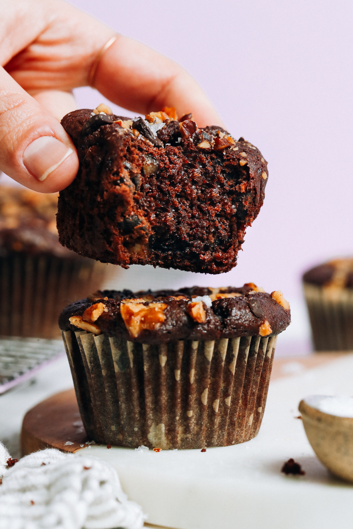 Holding a salted chocolate banana nut muffin to show the inner texture