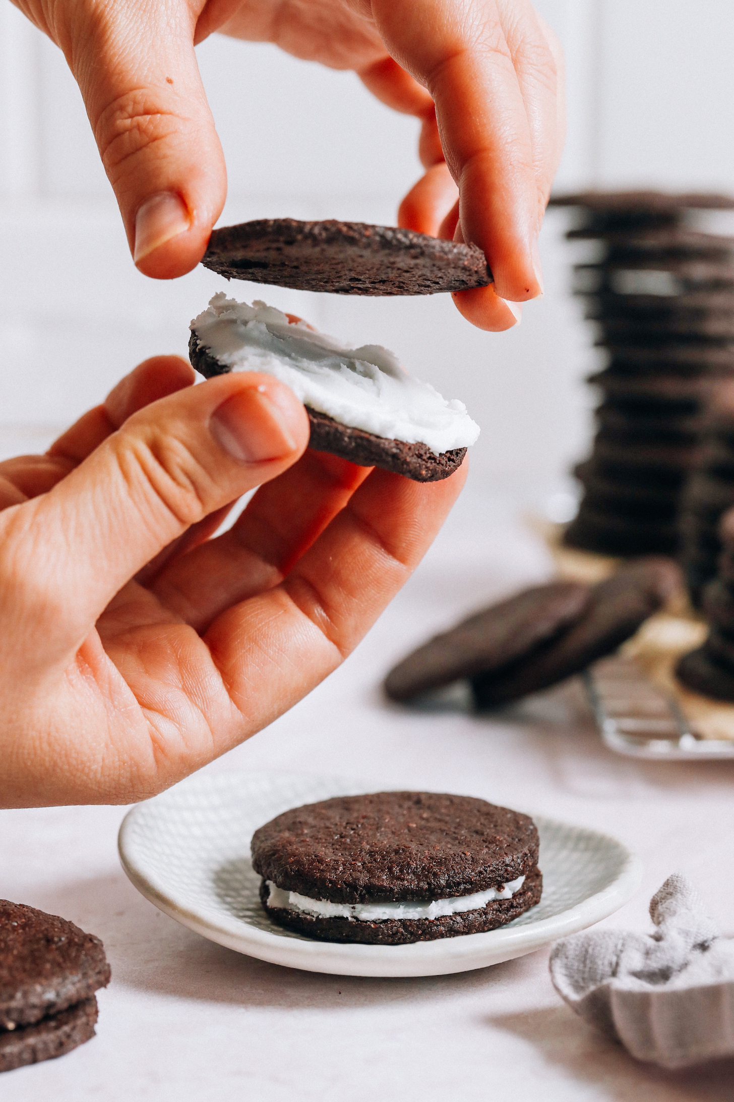 Sandwiching a sweet creamy filling between two chocolate cookies 
