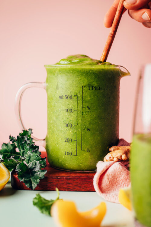 Measuring glass filled with our mango ginger kale green smoothie