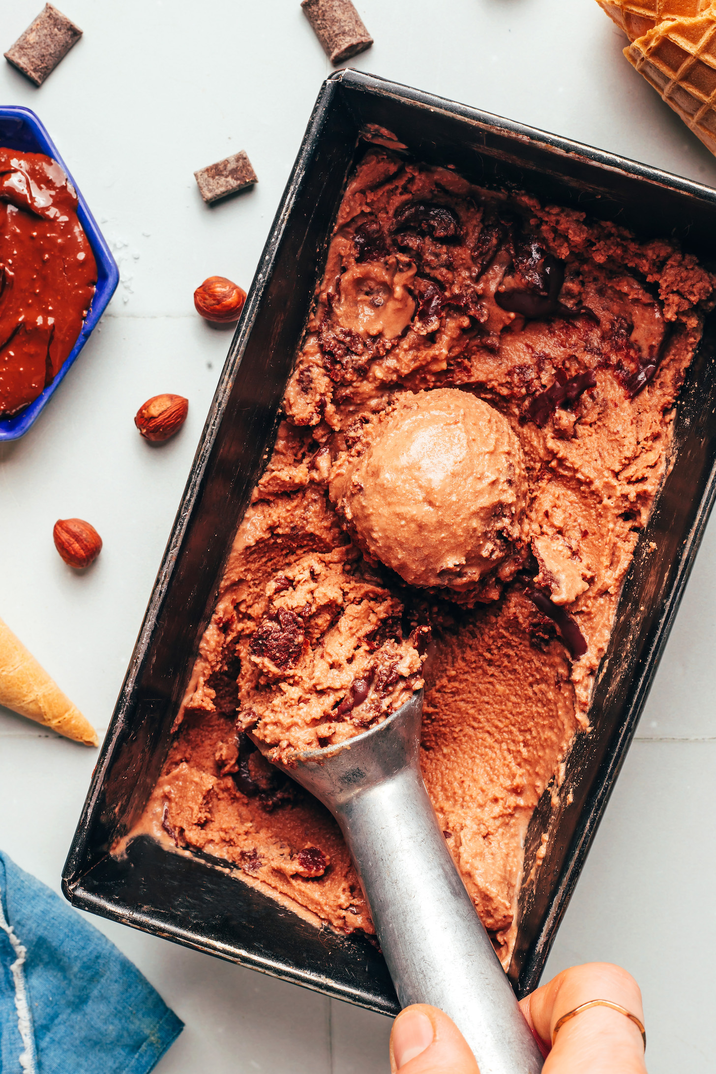 Ice cream scoop in a loaf pan of homemade Nutella ice cream