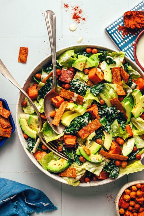 Serving spoon an fork resting in a bowl of our vegan taco salad recipe